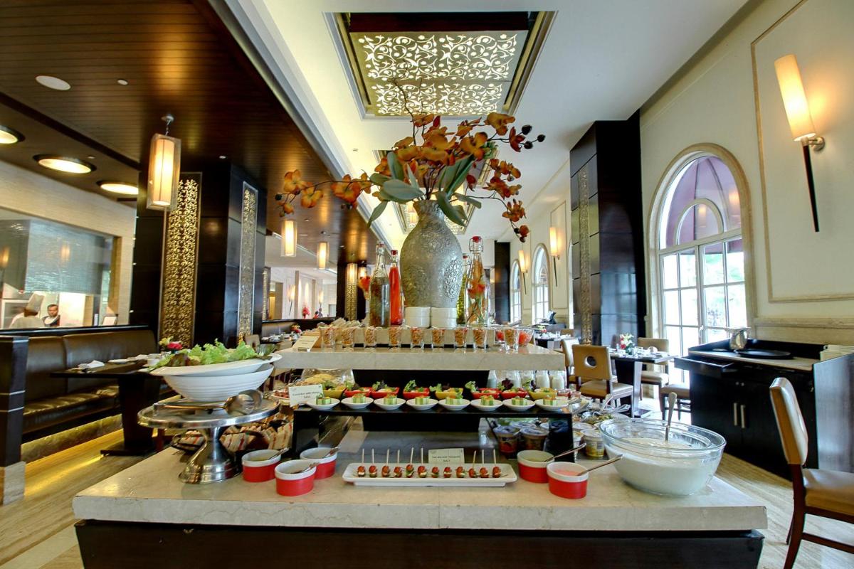 a buffet in a hotel with food on a table at The Pllazio Hotel in Gurgaon