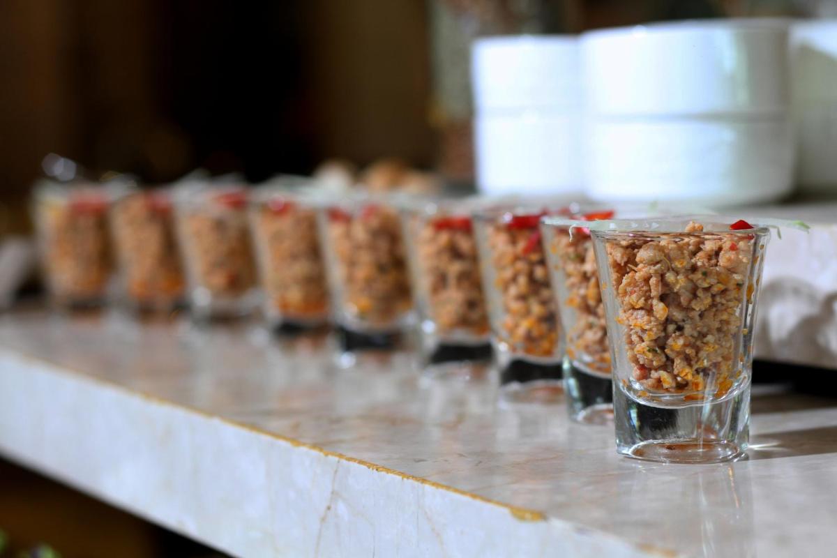 a row of glasses filled with food on a counter at The Pllazio Hotel in Gurgaon