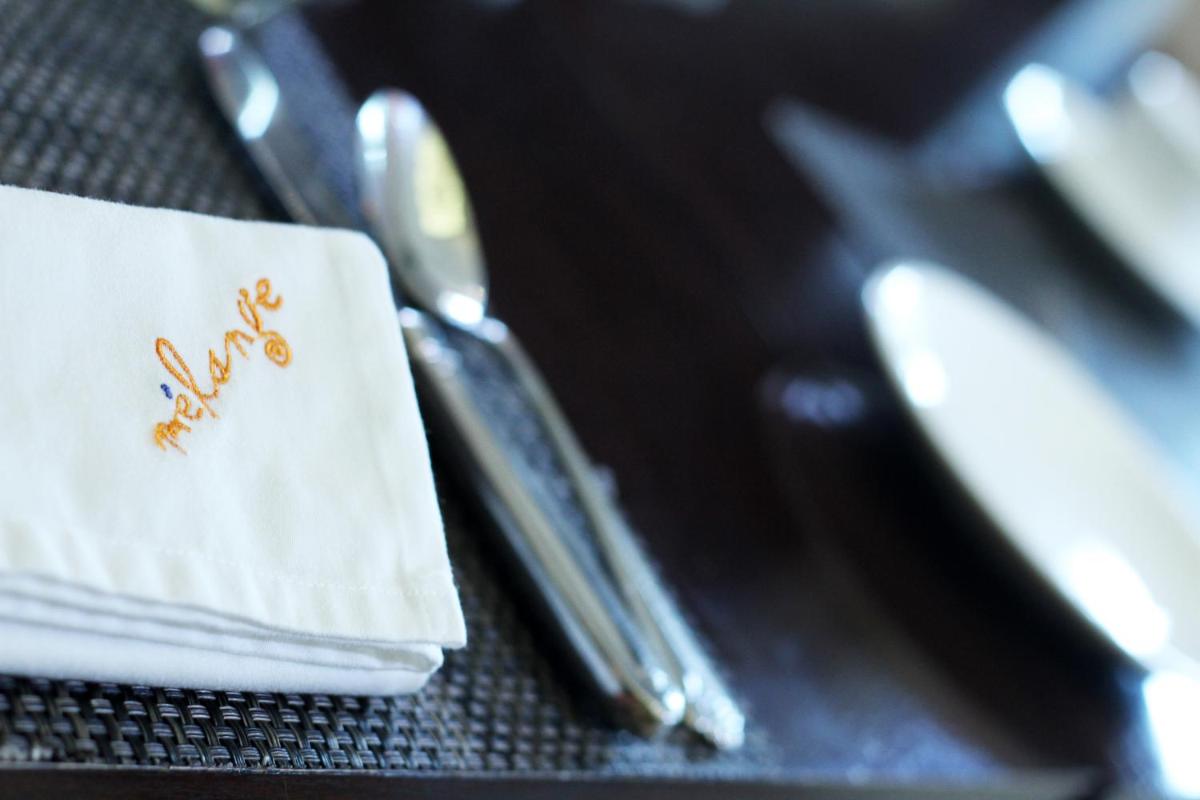 a table with a napkin and a knife and fork at The Pllazio Hotel in Gurgaon