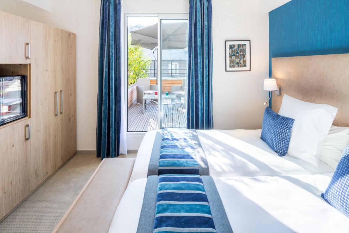 Un ou plusieurs lits dans un hébergement de l'établissement Hôtel Le Rive Droite & SPA