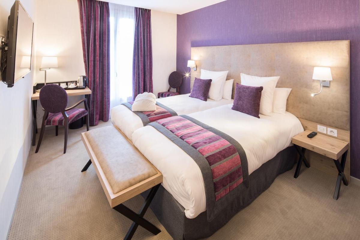 Un ou plusieurs lits dans un hébergement de l'établissement Hôtel Le Rive Droite & SPA