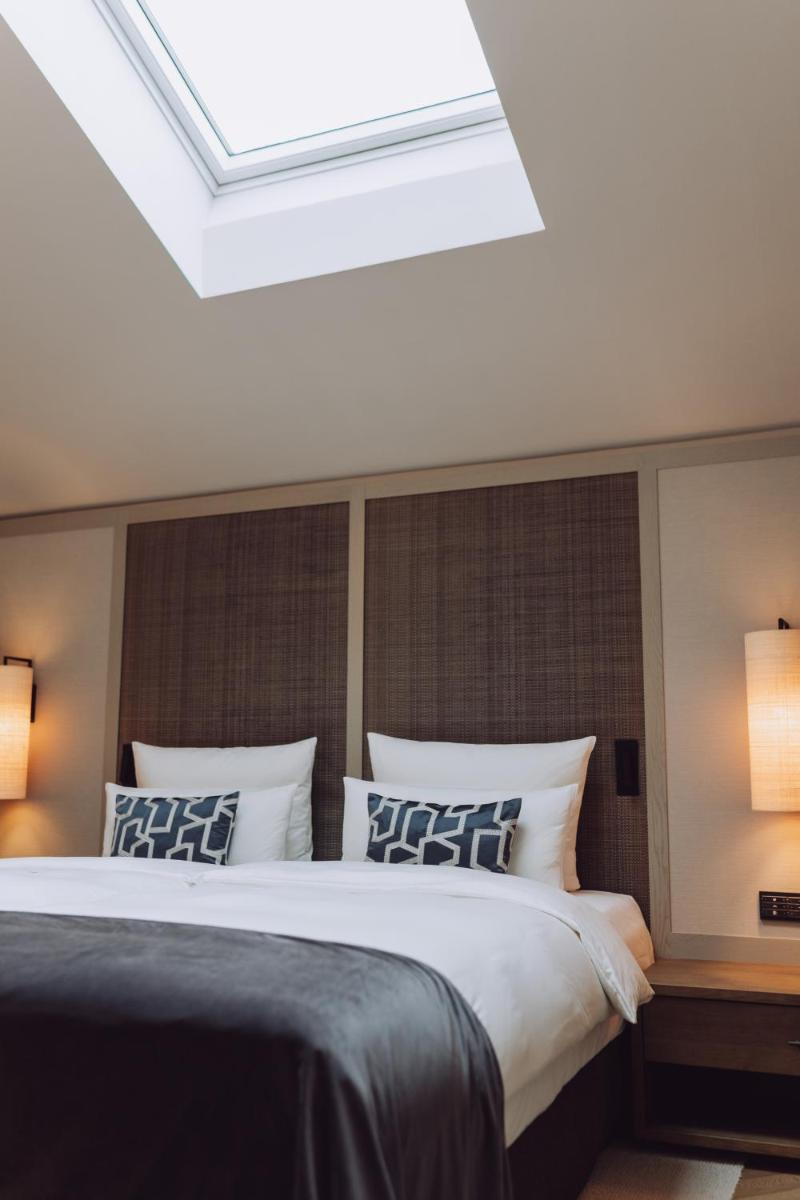 Ein Bett oder Betten in einem Zimmer der Unterkunft Parkhotel Egerner Höfe
