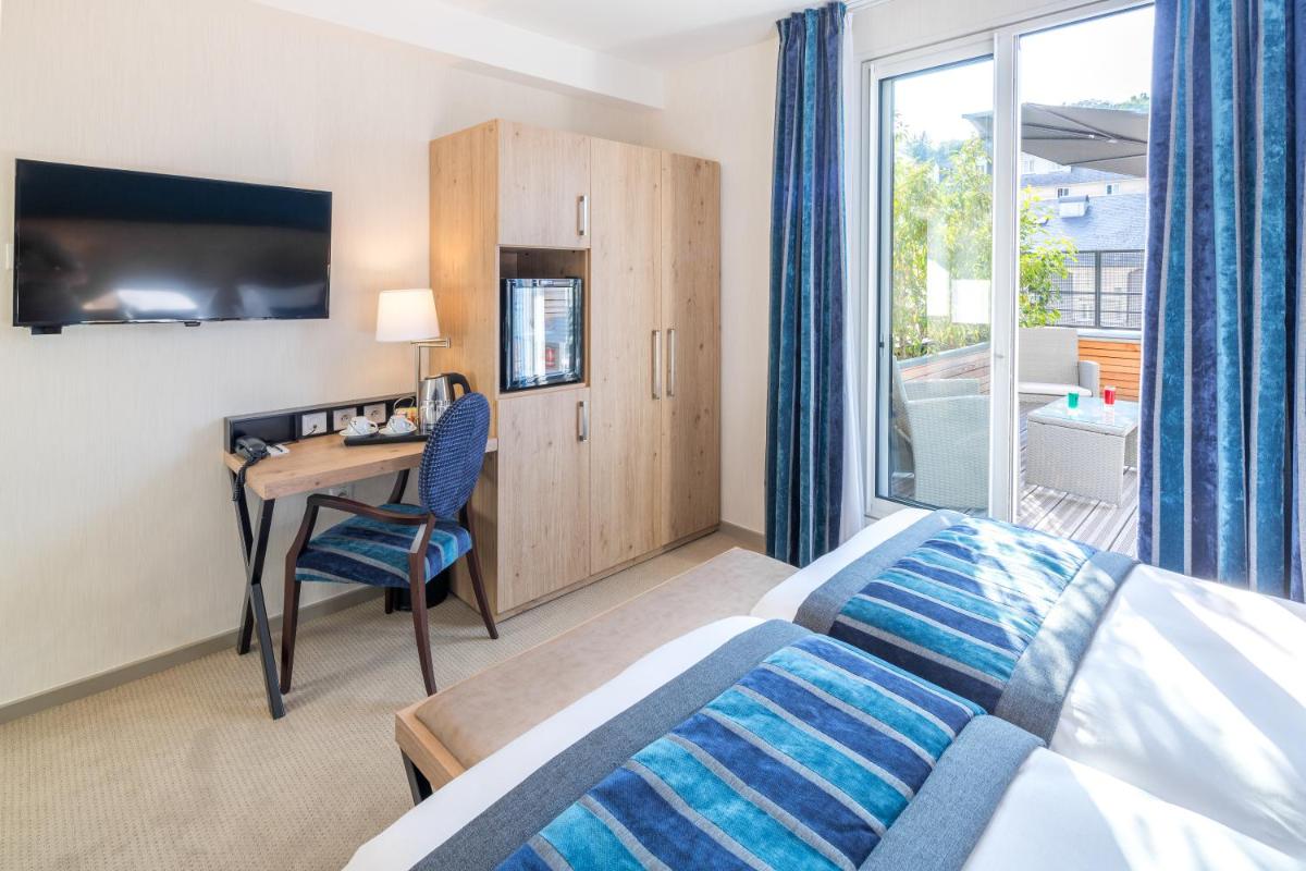 Un ou plusieurs lits dans un hébergement de l'établissement Hôtel Le Rive Droite & SPA