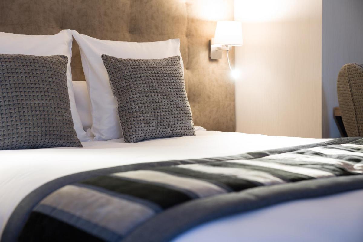 Un ou plusieurs lits dans un hébergement de l'établissement Hôtel Le Rive Droite & SPA