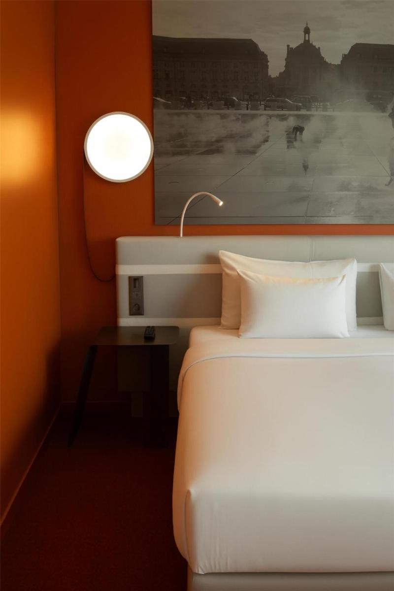 Un ou plusieurs lits dans un hébergement de l'établissement Radisson Blu Hotel Bordeaux