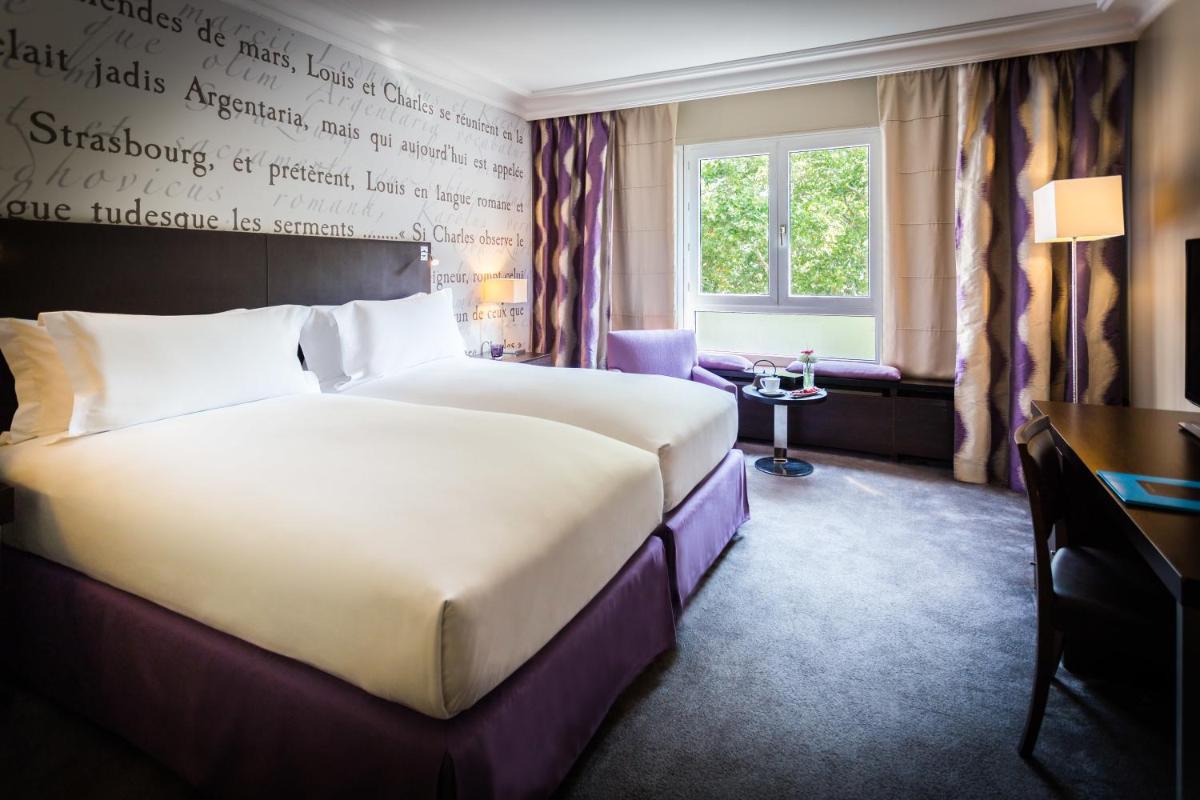 Un ou plusieurs lits dans un hébergement de l'établissement Sofitel Strasbourg Grande Ile