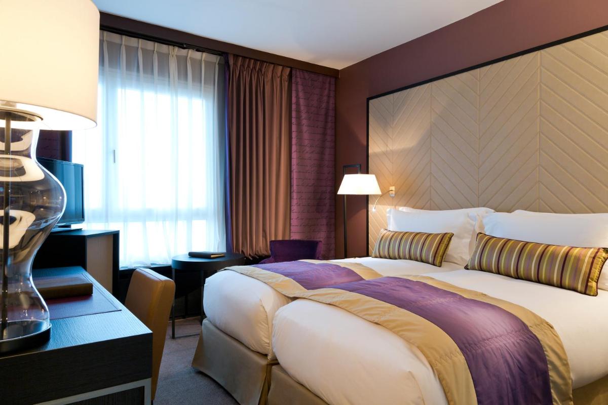 Un ou plusieurs lits dans un hébergement de l'établissement Sofitel Strasbourg Grande Ile