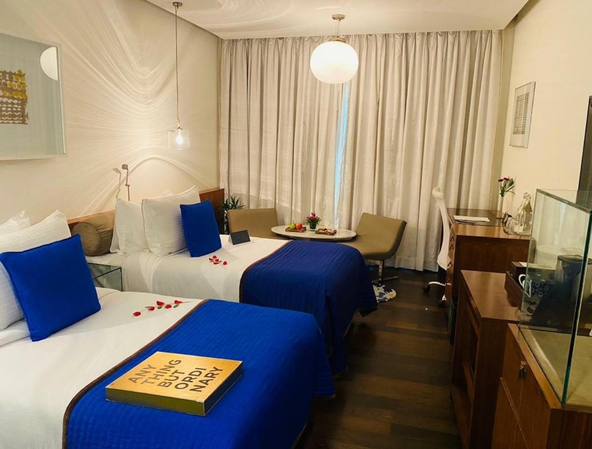a hotel room with two beds and a table at The Park New Delhi in New Delhi