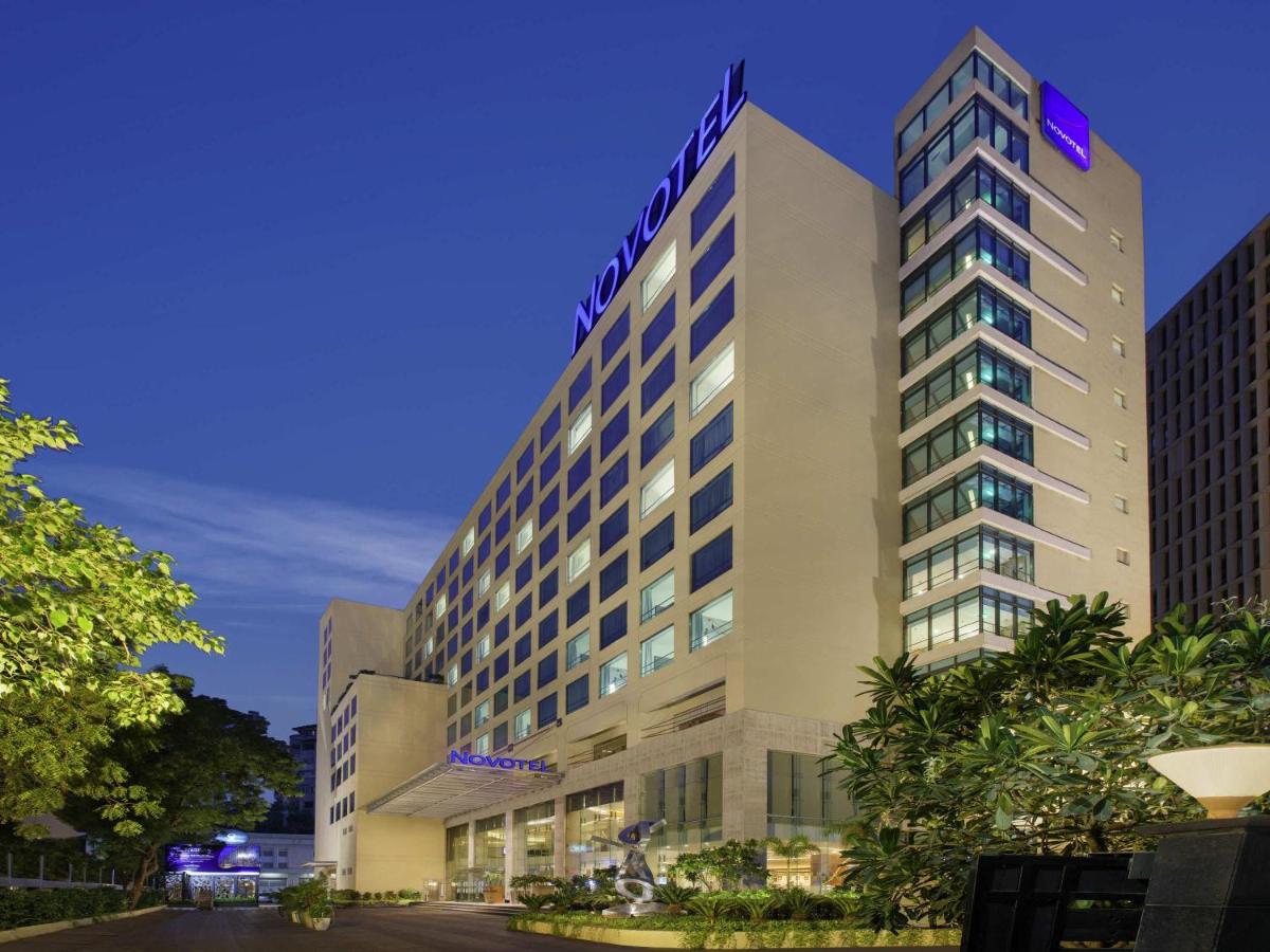 a tall building with a sign on top of it at Novotel Ahmedabad in Ahmedabad