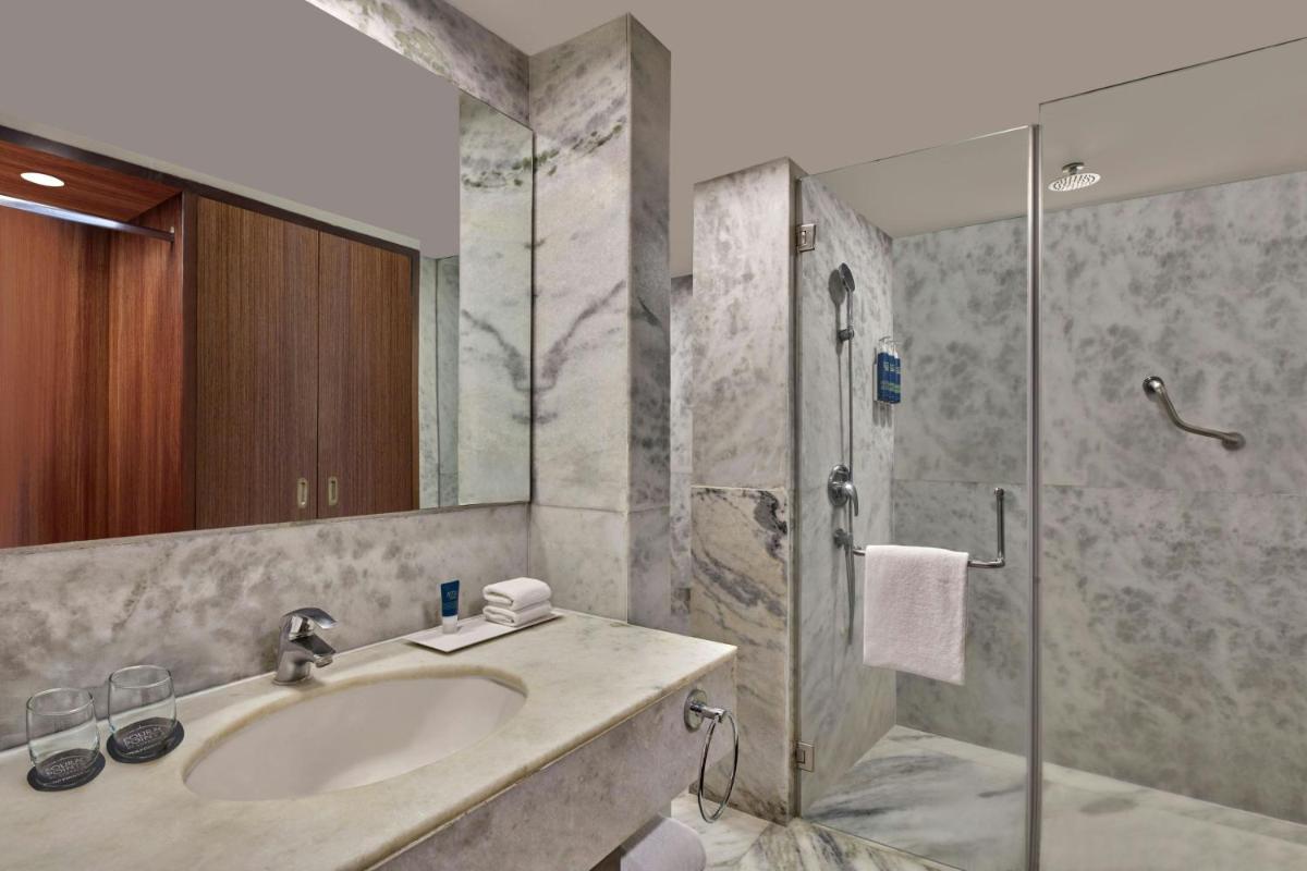 a bathroom with a sink and a shower at Four Points by Sheraton Hotel and Serviced Apartments Pune in Pune