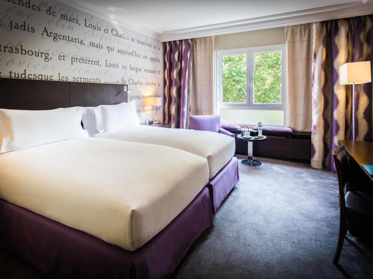 Un ou plusieurs lits dans un hébergement de l'établissement Sofitel Strasbourg Grande Ile