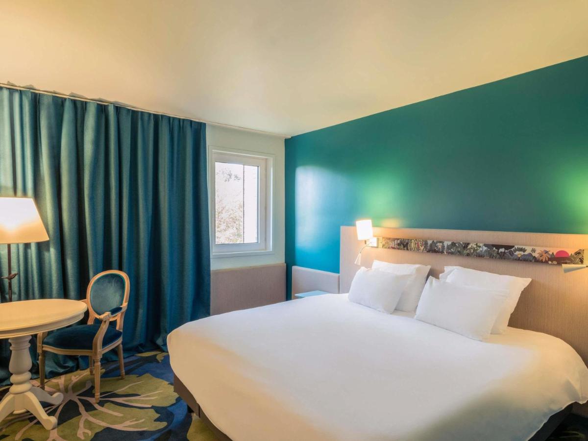 Un ou plusieurs lits dans un hébergement de l'établissement Hotel Mercure Parc du Coudray - Barbizon