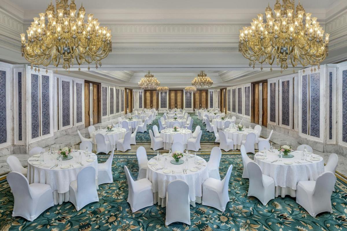 a ballroom with white tables and chairs and chandeliers at ITC Kakatiya, a Luxury Collection Hotel, Hyderabad in Hyderabad