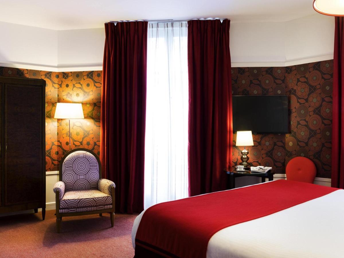 Un ou plusieurs lits dans un hébergement de l'établissement Carlton Hotel Lyon - MGallery Collection