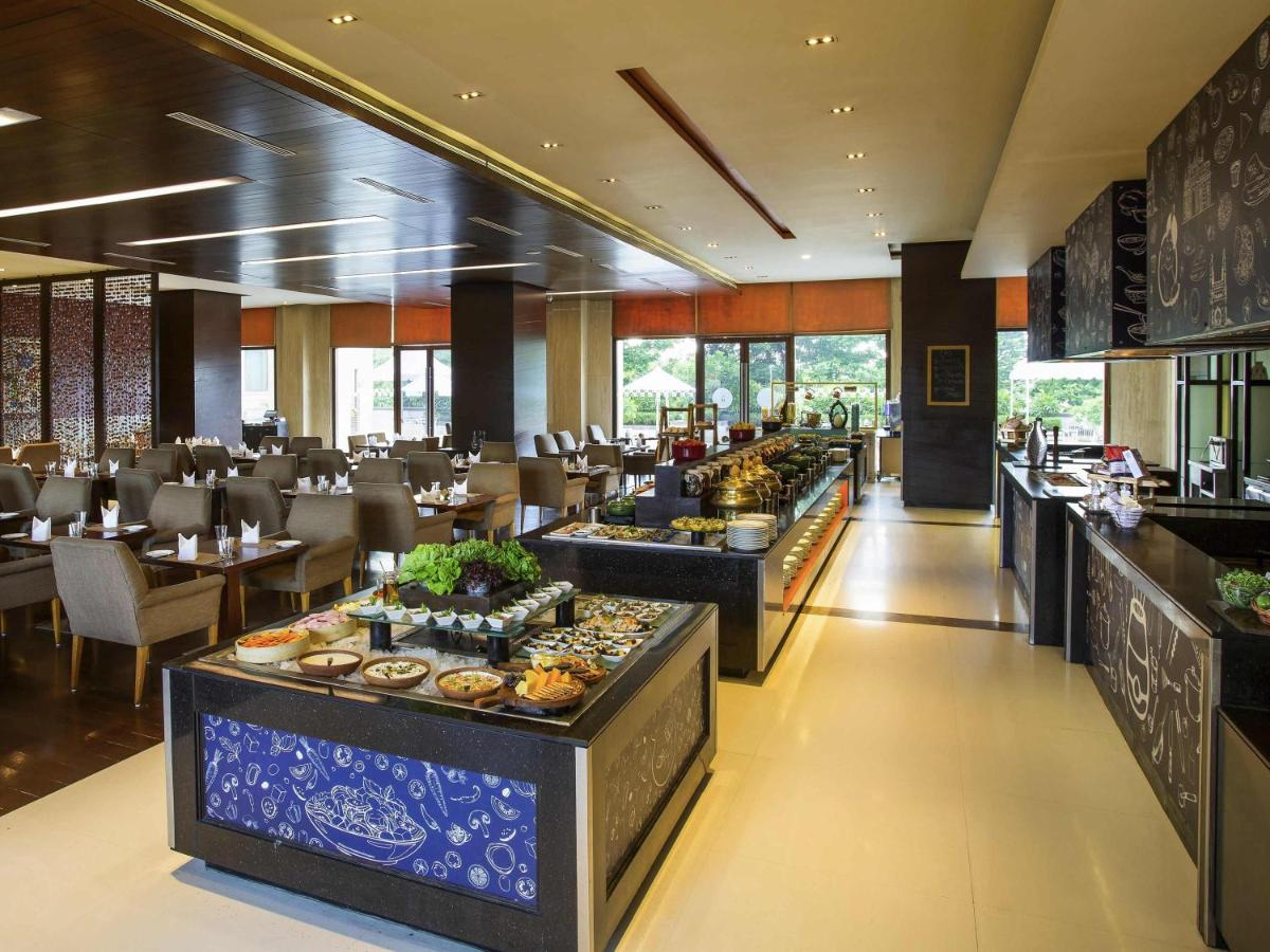 a restaurant with a buffet line with food on display at Novotel Hyderabad Airport in Hyderabad