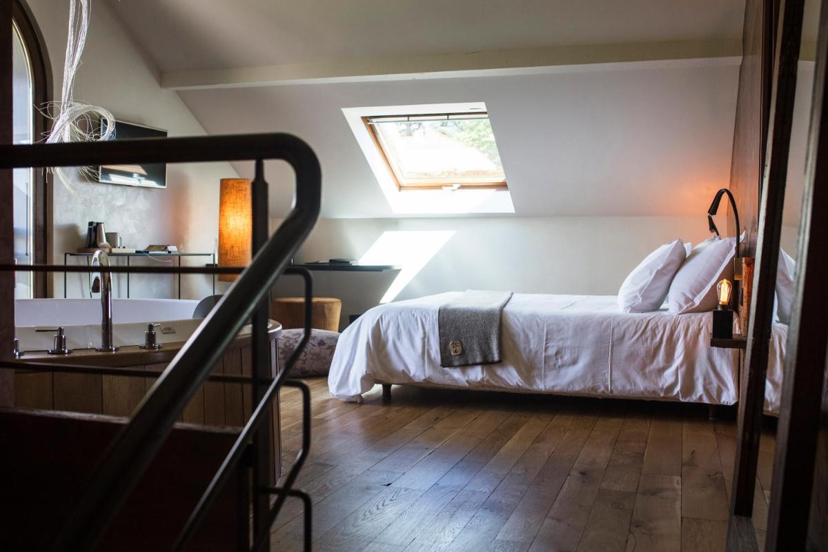 Un ou plusieurs lits dans un hébergement de l'établissement Le Clos Des Sens