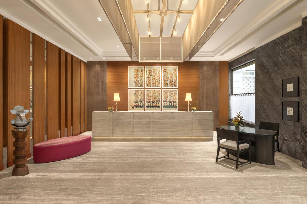a lobby with a waiting area with a reception desk at The Raintree, St. Mary’s Road in Chennai
