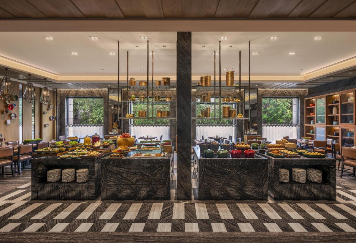 a buffet line with fruits and vegetables on display at The Raintree, St. Mary’s Road in Chennai