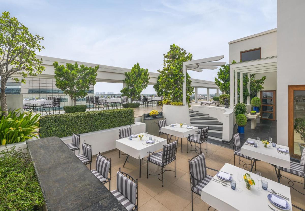 an image of a restaurant with tables and chairs at The Raintree, St. Mary’s Road in Chennai