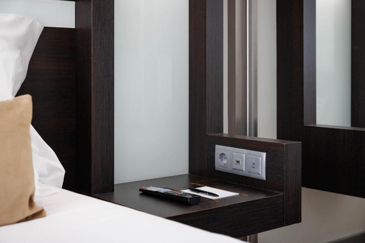 Uma cama ou camas num quarto em Jupiter Lisboa Hotel - Rooftop & Spa