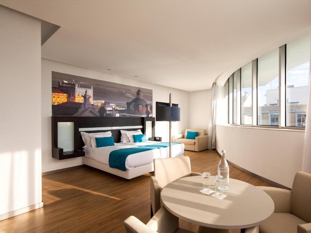 Uma cama ou camas num quarto em Jupiter Lisboa Hotel - Rooftop & Spa