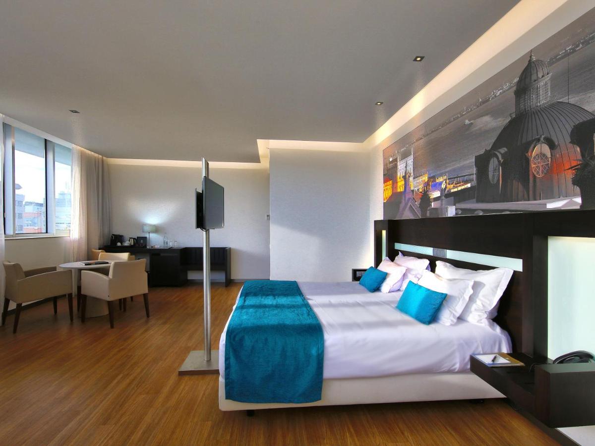 Uma cama ou camas num quarto em Jupiter Lisboa Hotel - Rooftop & Spa