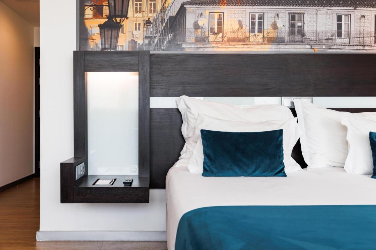 Uma cama ou camas num quarto em Jupiter Lisboa Hotel - Rooftop & Spa