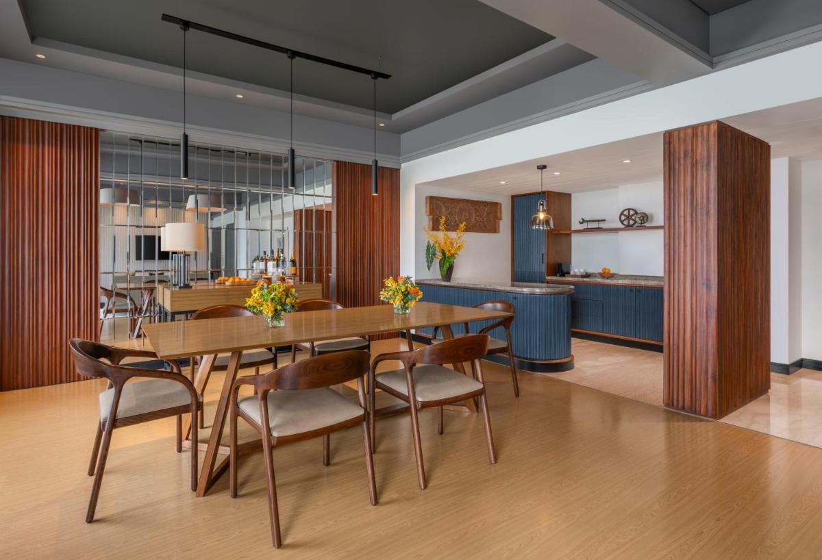 a dining room with a table and chairs at The Raintree, St. Mary’s Road in Chennai