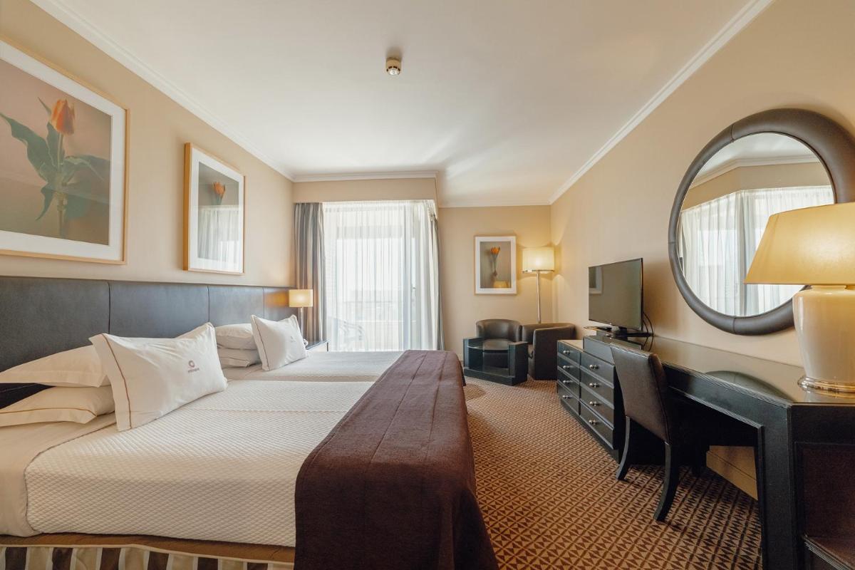 Uma cama ou camas num quarto em Hotel Solverde Spa and Wellness Center
