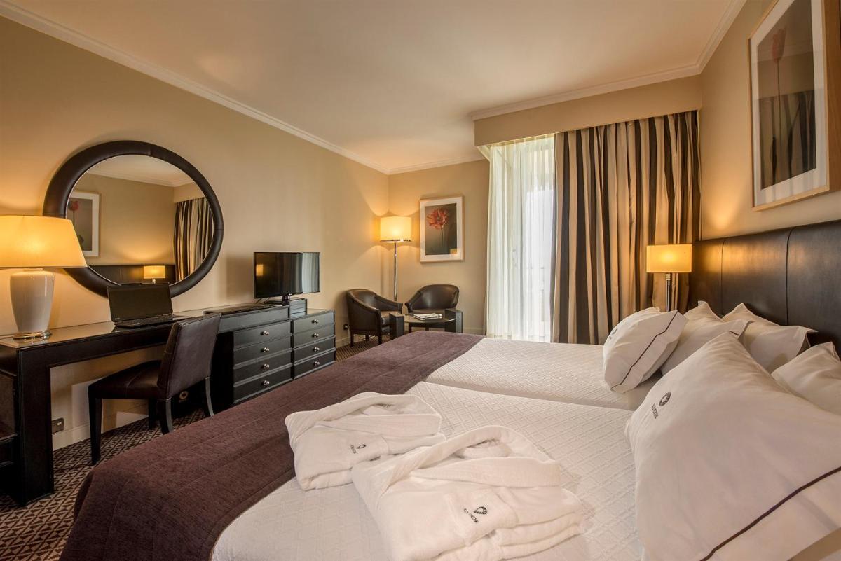 Uma cama ou camas num quarto em Hotel Solverde Spa and Wellness Center