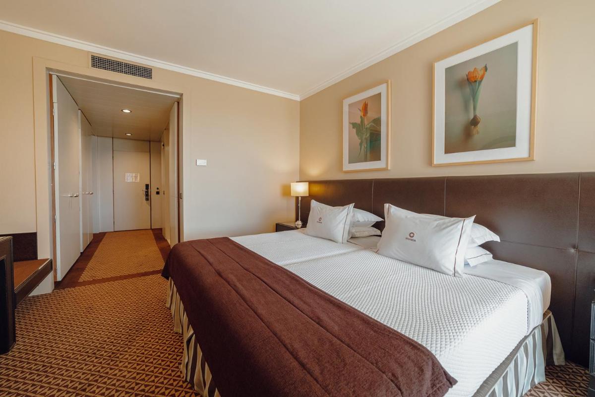 Uma cama ou camas num quarto em Hotel Solverde Spa and Wellness Center