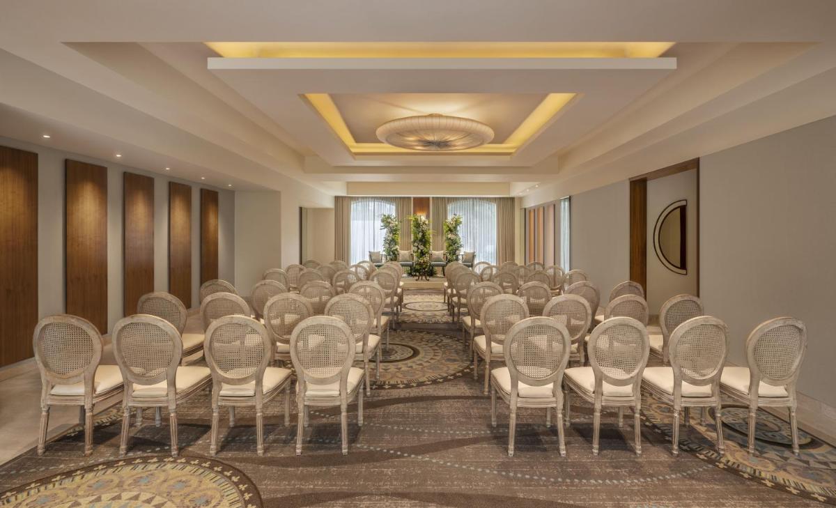 a room with a bunch of chairs in a room at The Raintree, St. Mary’s Road in Chennai