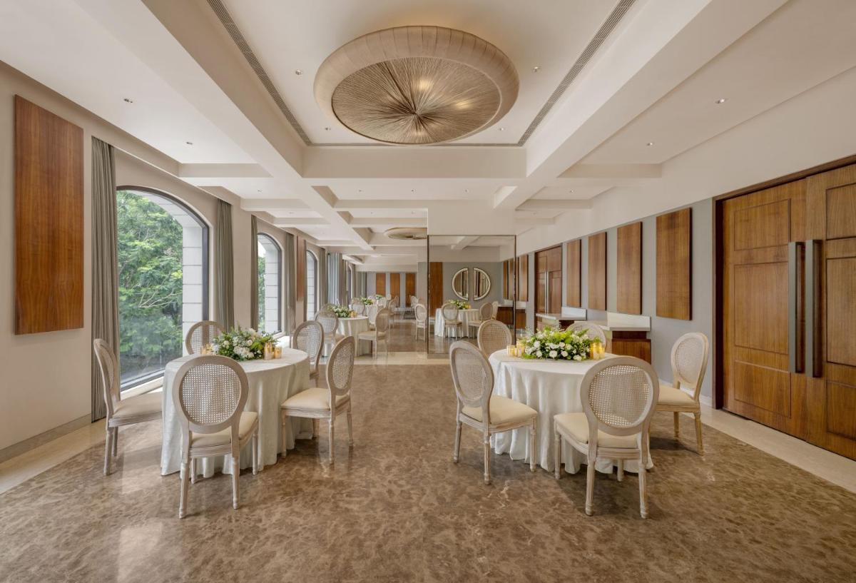 a meeting room with tables and chairs in a building at The Raintree, St. Mary’s Road in Chennai