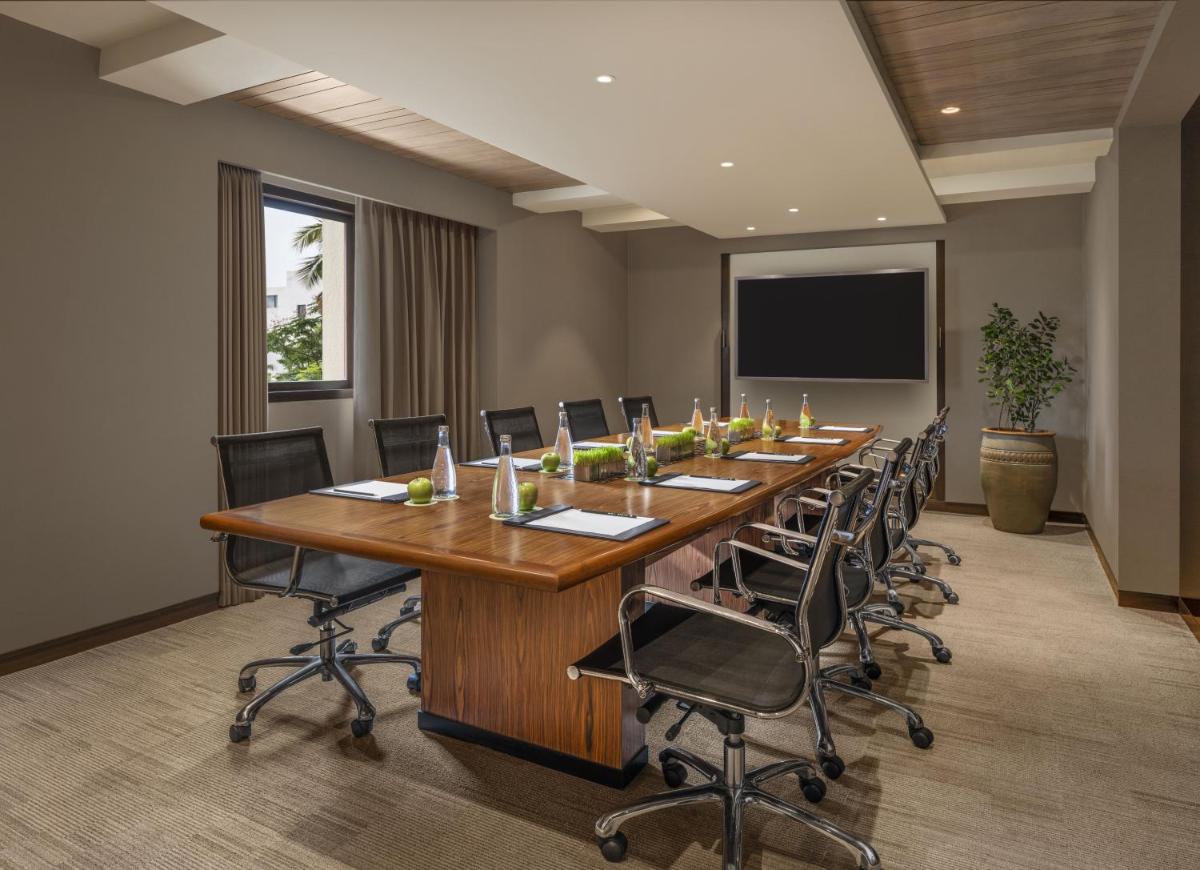 a large conference room with a long table and chairs at The Raintree, St. Mary’s Road in Chennai