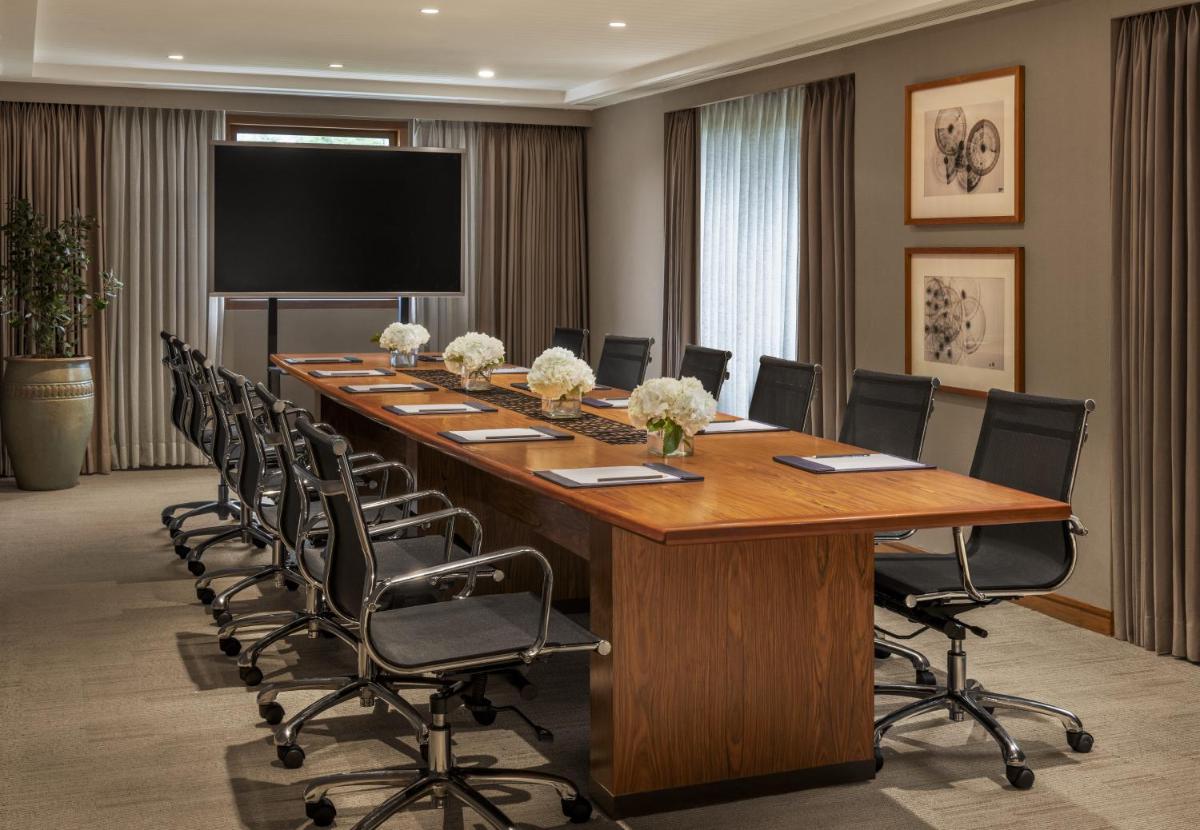 a large conference room with a long table and chairs at The Raintree, St. Mary’s Road in Chennai