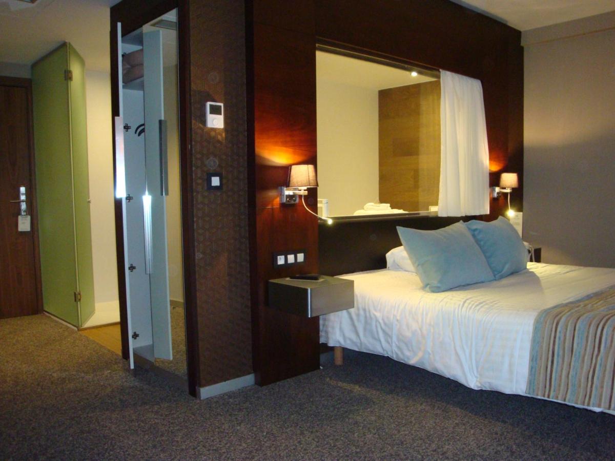 Un ou plusieurs lits dans un hébergement de l'établissement Alysson Hôtel