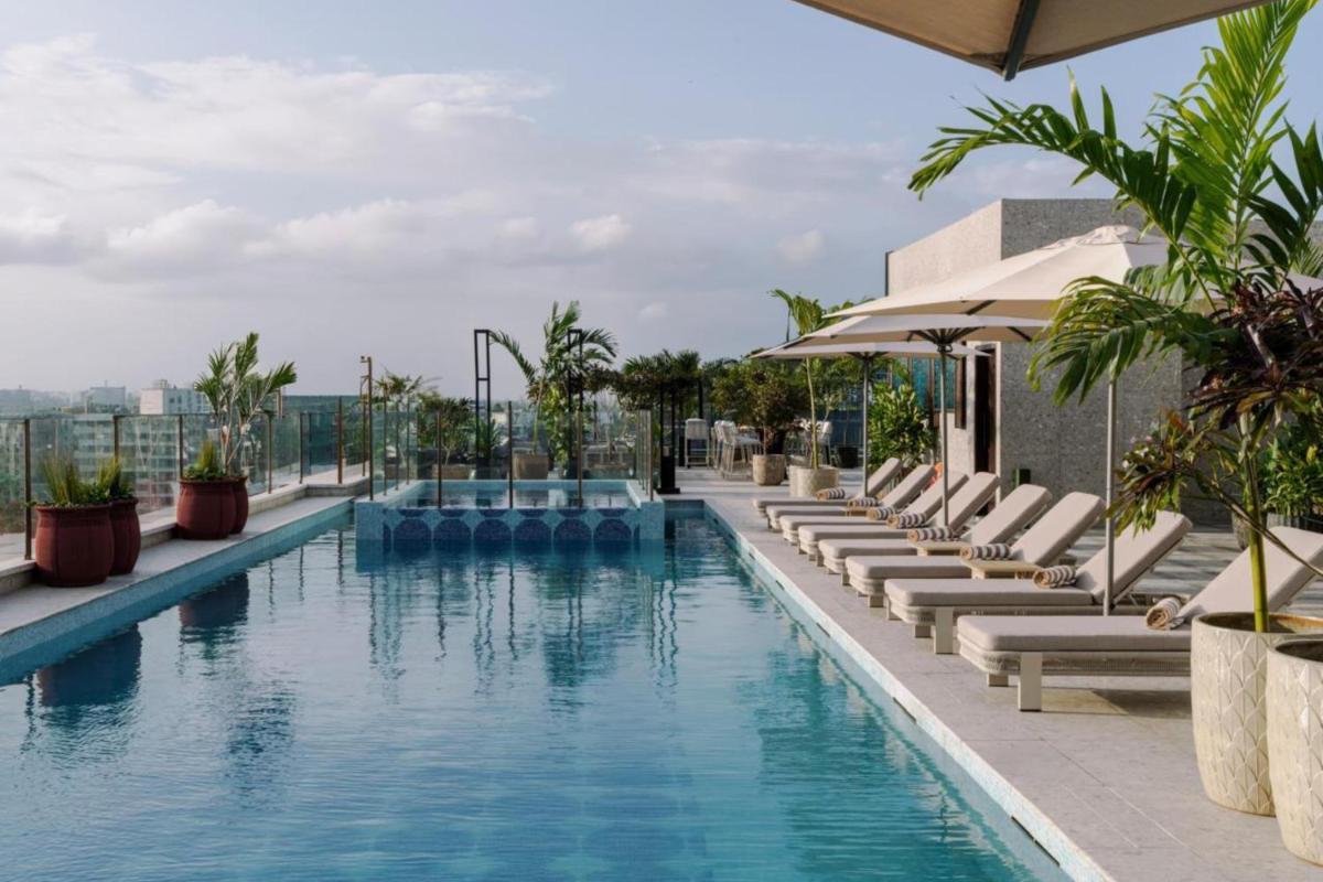 a swimming pool on the roof of a building at Radisson Blu Hotel Pune Kharadi in Pune