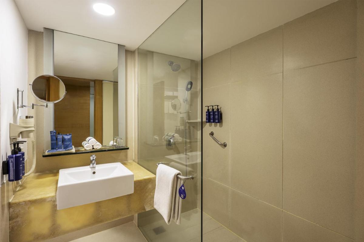 a bathroom with a sink and a shower at Radisson Blu Hotel Pune Kharadi in Pune