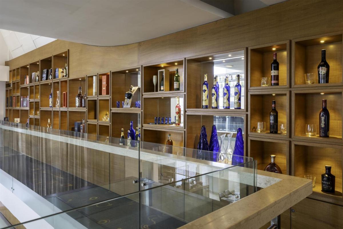 a room filled with shelves filled with bottles of wine at Radisson Blu Hotel Pune Kharadi in Pune