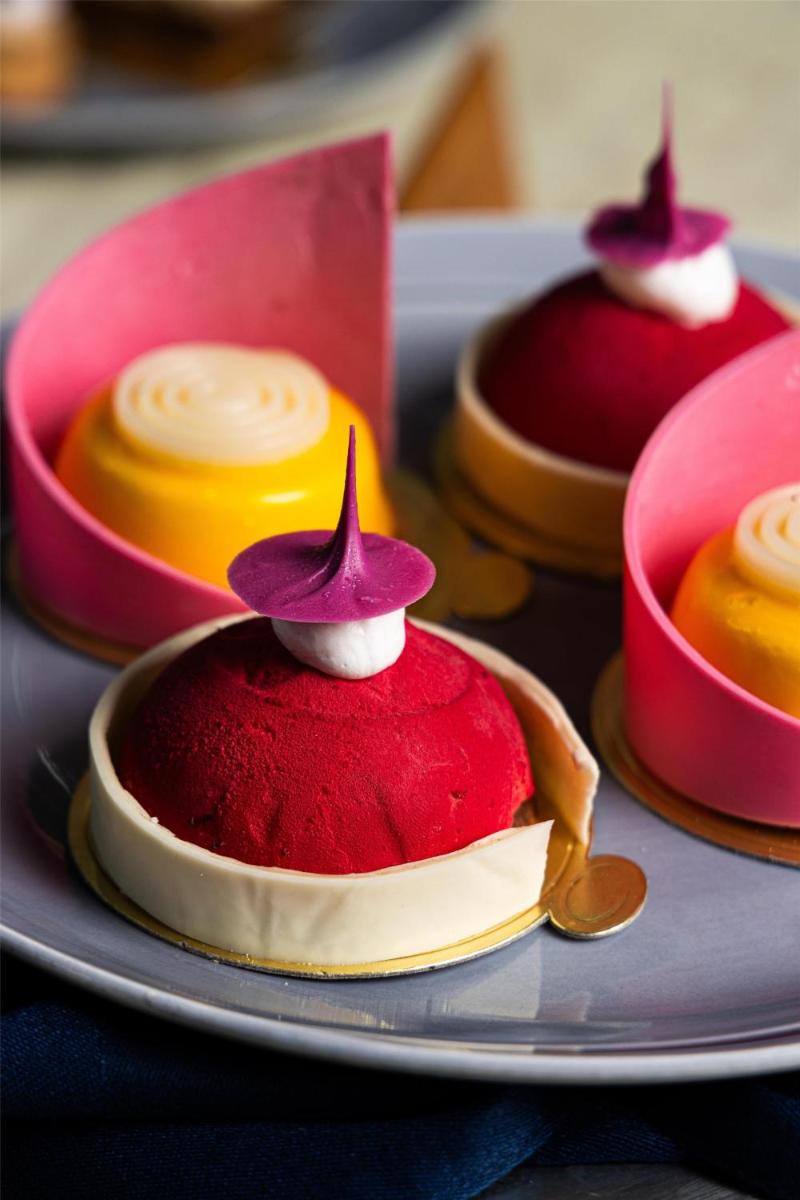 a plate of red velvet desserts on a table at Radisson Blu Hotel Pune Kharadi in Pune