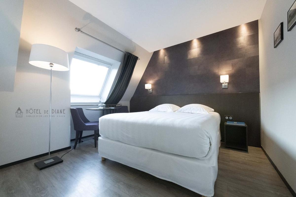 Un ou plusieurs lits dans un hébergement de l'établissement Hotel De Diane
