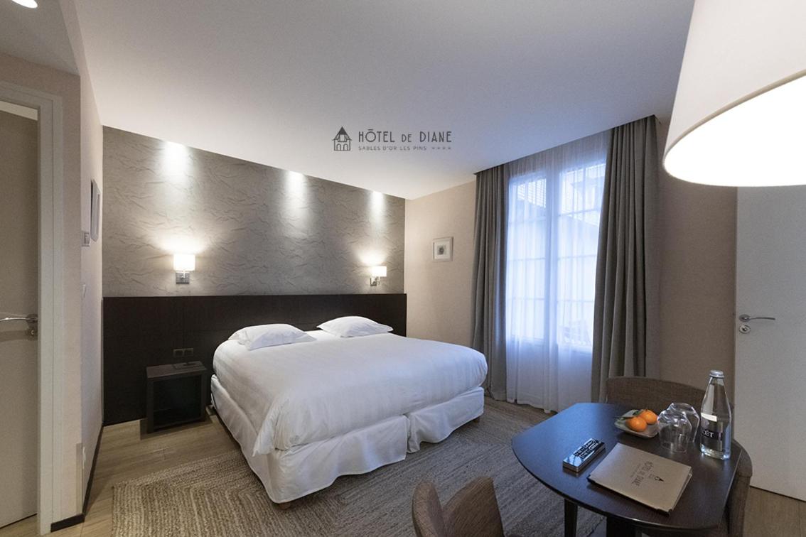 Un ou plusieurs lits dans un hébergement de l'établissement Hotel De Diane