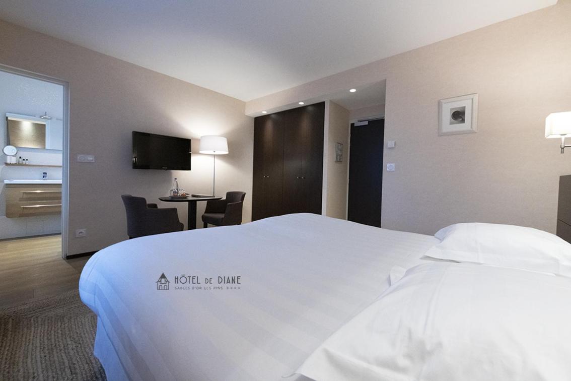 Un ou plusieurs lits dans un hébergement de l'établissement Hotel De Diane