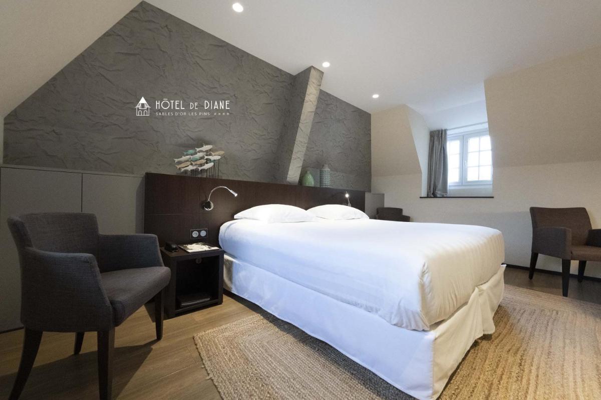 Un ou plusieurs lits dans un hébergement de l'établissement Hotel De Diane