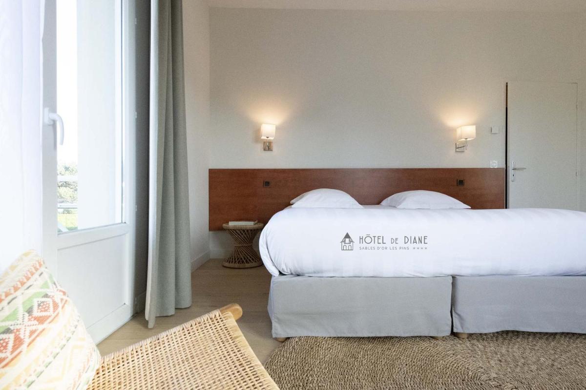 Un ou plusieurs lits dans un hébergement de l'établissement Hotel De Diane