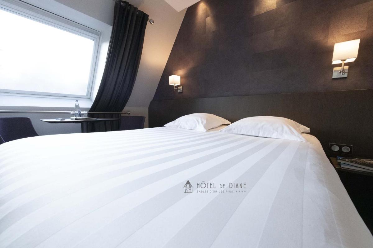 Un ou plusieurs lits dans un hébergement de l'établissement Hotel De Diane
