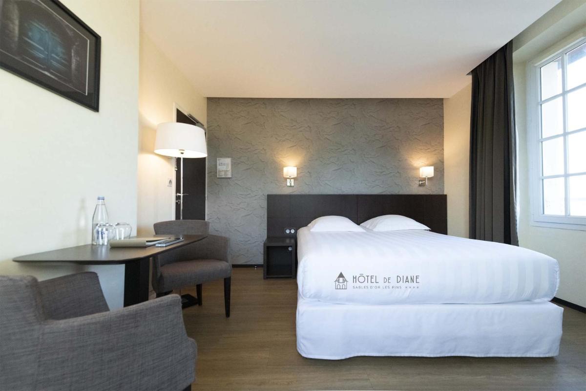 Un ou plusieurs lits dans un hébergement de l'établissement Hotel De Diane