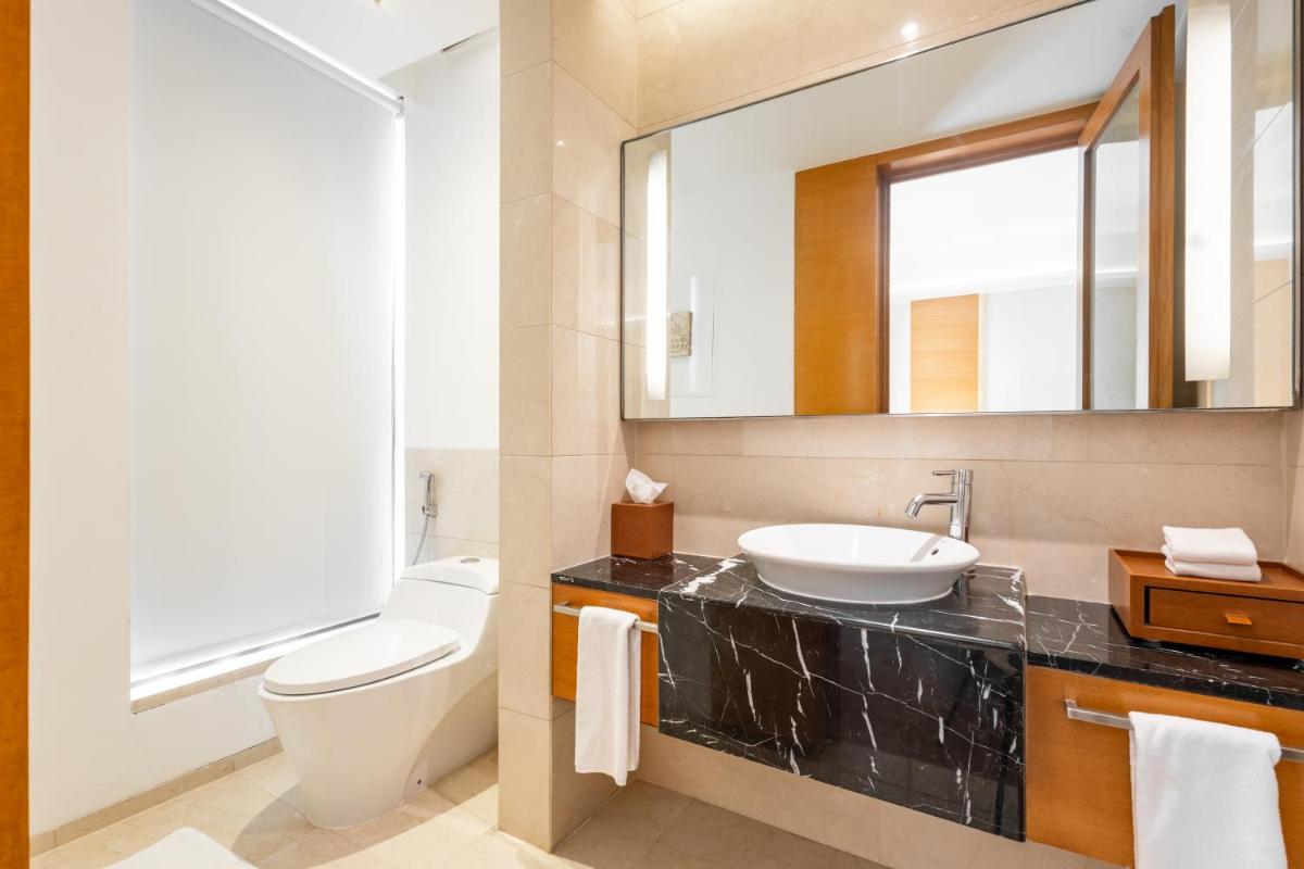a bathroom with a sink and a toilet and a mirror at Hyatt Pune in Pune