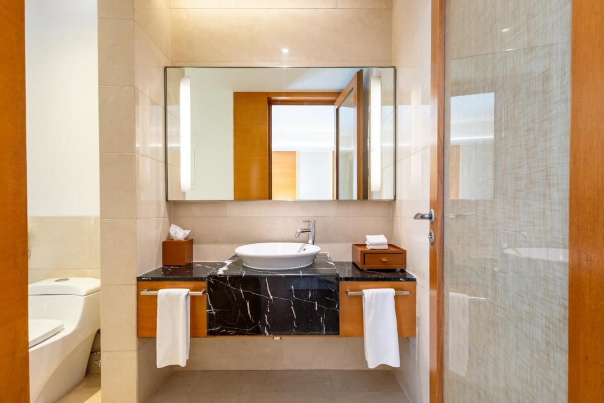 a bathroom with a sink and a mirror at Hyatt Pune in Pune