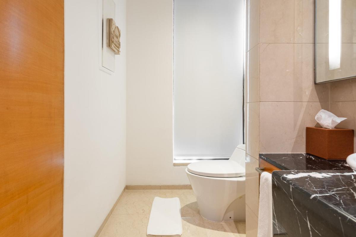 a bathroom with a toilet and a sink at Hyatt Pune in Pune